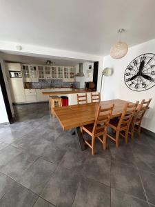 a kitchen and dining room with a wooden table and chairs at Altavilloise Pétillante in Hautvillers
