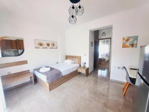 a bedroom with a bed and a table in a room at Mitende Apartments in Kallithea Halkidikis