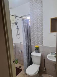 a bathroom with a toilet and a sink at More than Space Staycation in Sampong