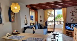 a living room with a blue couch and a table at Vivienda Vacacional Parque Santiago 1 Bernal Home in Arona
