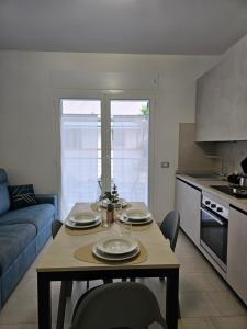 a kitchen with a table with plates on it at Grey House1 100m to the beach in Tortoreto Lido +24 photos