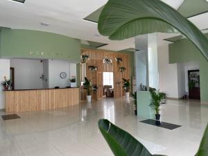 a lobby with a waiting area with potted plants at Hotel Aeetes Kobuleti in Kobuleti