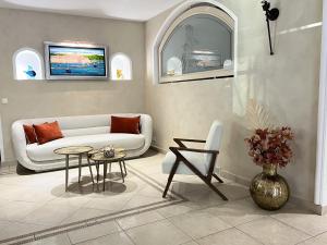 a living room with a couch and a table at Hôtel Beau Site - Cap d'Antibes in Antibes