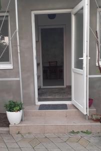 an open door of a house with a table at Домик в общем дворе с хозяином in Komrat