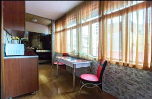 a kitchen with a table and chairs in a room at Квартира у бульвара 1 in Batumi +9 photos
