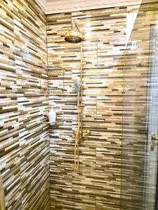 a bathroom with a shower with a stone wall at FD luxury apartment in Verona +5 photos