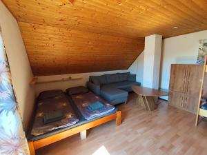 a living room with a couch and a table at Chata Hulina in Moderštôlňa