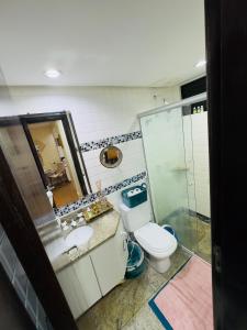 ein Badezimmer mit Toilette, Waschbecken und Dusche in der Unterkunft Brasília - Lakeside Apartamento in Brasilia