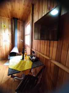a wooden room with a table and a television on the wall at Paraíso Dos Cânions in Bom Jardim da Serra +73 photos
