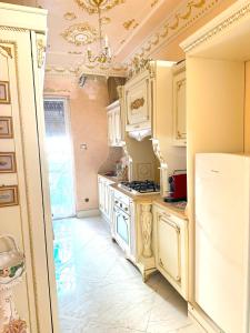 a kitchen with white cabinets and a stove top oven at FD luxury apartment in Verona