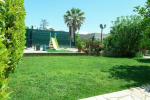 a yard with a playground with a slide at Provençale de Biot in Biot