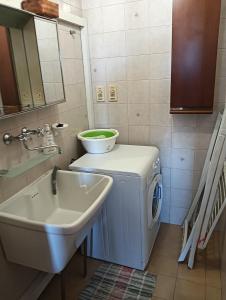 a bathroom with a sink and a washing machine at Casa Luciana in Maglie