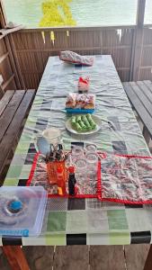 a picnic table with a plate of food on it at Homestay Yenbeyar Raja Ampat in Yariffi