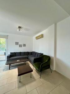a living room with a couch and a chair at Cozy Stay Nicosia in Nicosia