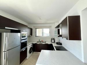 a kitchen with a stainless steel refrigerator and a dishwasher at Cozy Stay Nicosia in Nicosia +20 photos