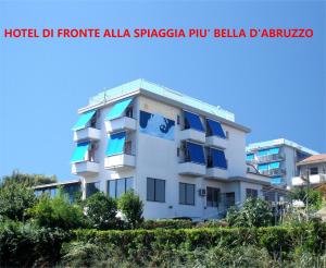 a white building with blue balconies on it at Hotel Mare Blu -- boutique in Pineto