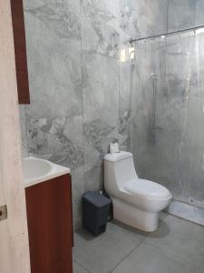 a bathroom with a toilet and a sink and a shower at Hermosa Casa en Juana Vicenta Samana in Santa Bárbara de Samaná