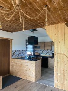 a kitchen with wooden walls and a wooden ceiling at Mazurski Reset in Wilnowo