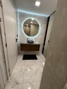 a bathroom with a sink and a mirror at Harley Quinn Apartment in Poprad