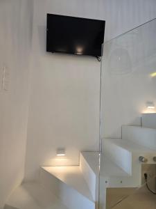 a television hanging on a wall in a room at Hotel Alexandra in Skala