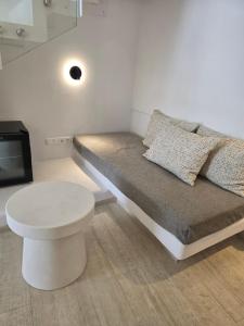 a room with a bed with a stool and a tv at Hotel Alexandra in Skala