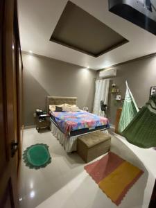 a bedroom with a bed and a hammock in it at Casa cop 30 in Belém
