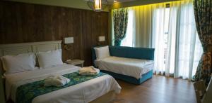 A bed or beds in a room at Irene's Resort