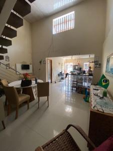 a living room with a staircase and a table and chairs at Casa cop 30 in Belém