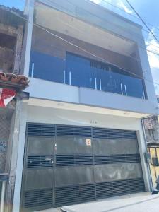 a building with a large garage door on it at Casa cop 30 in Belém