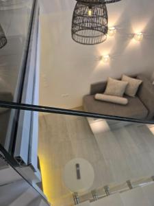 a glass table with a couch in a room at Hotel Alexandra in Skala