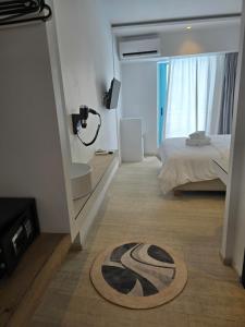 a bedroom with a bed and a rug on the floor at Hotel Alexandra in Skala
