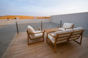 two chairs and a table on a roof at Remal Resort Bidiyah in Badīyah +51 photos