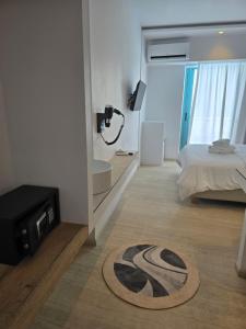 a room with a bed and a bathroom with a mirror at Hotel Alexandra in Skala