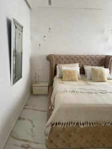 a bedroom with a large bed and a mirror at Monte Cabo in Cabo Negro +30 photos