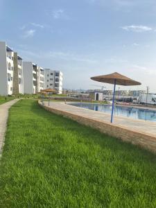 a row of umbrellas next to a swimming pool at Monte Cabo in Cabo Negro