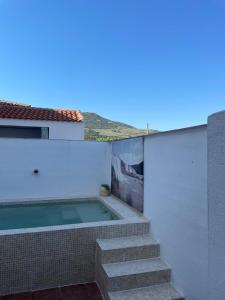 a swimming pool on the side of a house at Casa Rural La Bienservida in Bienservida