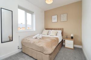 a bedroom with a large bed and a window at Cowpen Lodge in Stockton-on-Tees