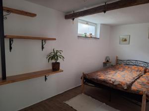 a bedroom with a bed and a potted plant at Sunny Karla apartment Dramlje in Dramlje