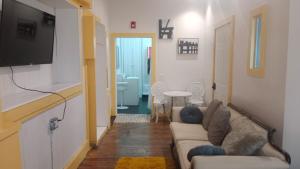 a living room with a couch and a flat screen tv at Michie Hostel in Providence +61 photos