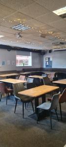 a room with tables and chairs in a building at The Bear On The Square in Millom