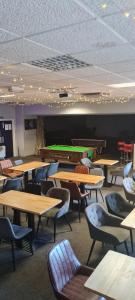 a classroom with tables and chairs and a pool table at The Bear On The Square in Millom