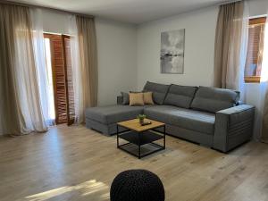 a living room with a couch and a table at Peaceful New Country House with Saltwater Pool in Brgud