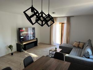 a living room with a couch and a tv at Peaceful New Country House with Saltwater Pool in Brgud
