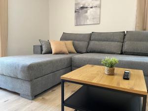 a living room with a couch and a coffee table at Peaceful New Country House with Saltwater Pool in Brgud +39 photos