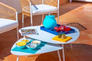 a table with two chairs and a tray of food at De Pando Panoramic Suites 1096 in Scala