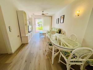 a living room with a dining room table and chairs at Calas Font Nova-BookApartments in Peñíscola
