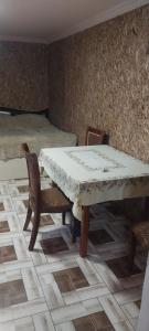 a room with a table and chairs and a bed at Meghri Hotel in Meghri