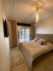 a bedroom with a large bed and a window at luxury sea view apartment in Tangier