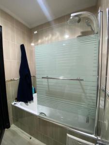 a shower with a glass door in a bathroom at luxury sea view apartment in Tangier +28 photos
