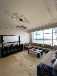 a living room with a couch and a tv at luxury sea view apartment in Tangier